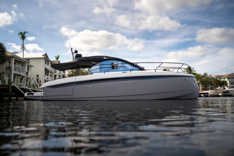  Yacht Photos Pics 2026 Beneteau Gran Turismo 40 yacht on calm water, modern design, under a partly cloudy sky.