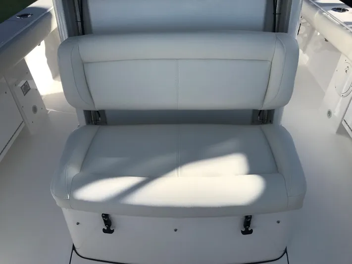 #339 White Yacht Photos Pics 2023 Everglades 273CC boat seat with white cushioned upholstery.