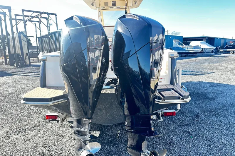  Yacht Photos Pics 2023 Scout 277 LXF boat with dual outboard motors in a marina setting.