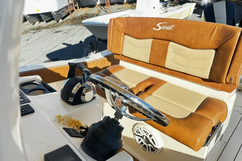  Yacht Photos Pics 2023 Scout 277 LXF boat interior with leather seating and steering wheel.