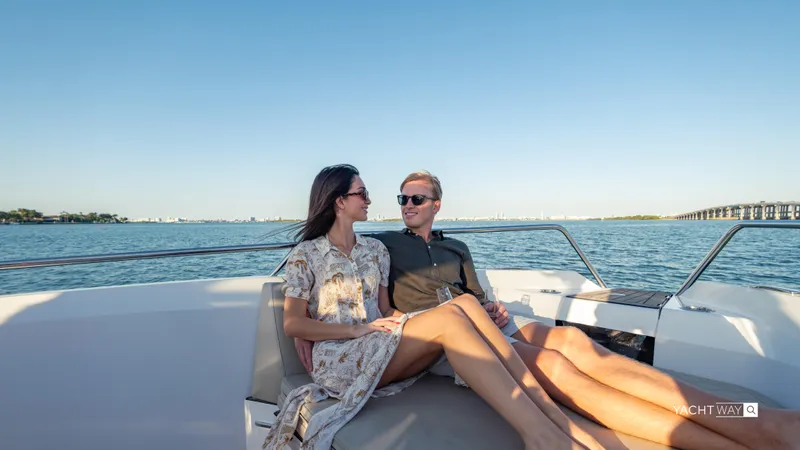  Yacht Photos Pics Couple relaxing on a 2025 Rand Roamer yacht, enjoying a sunny day on the water.