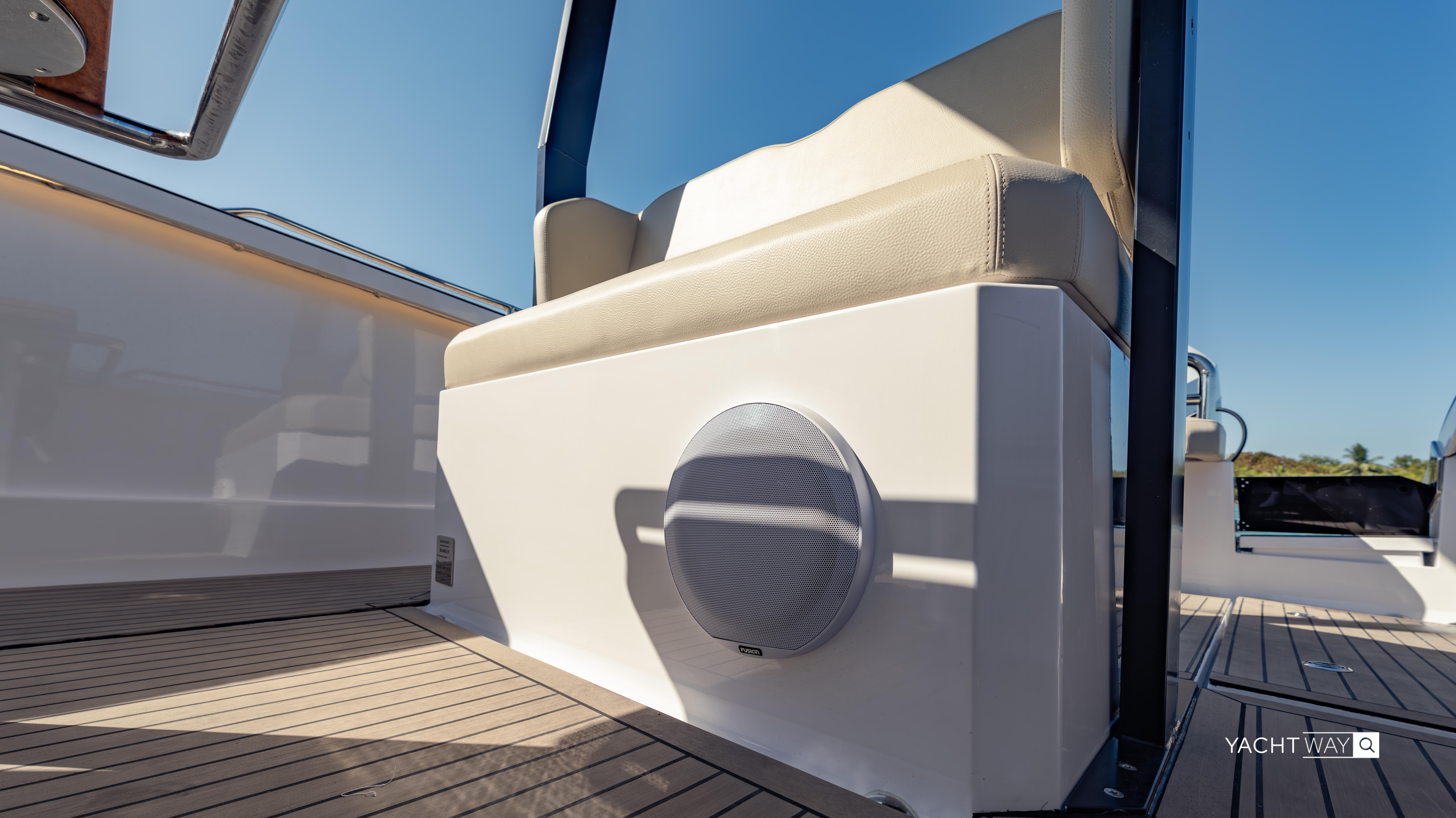 2025 Rand Roamer boat interior with cushioned seating and speaker on deck.