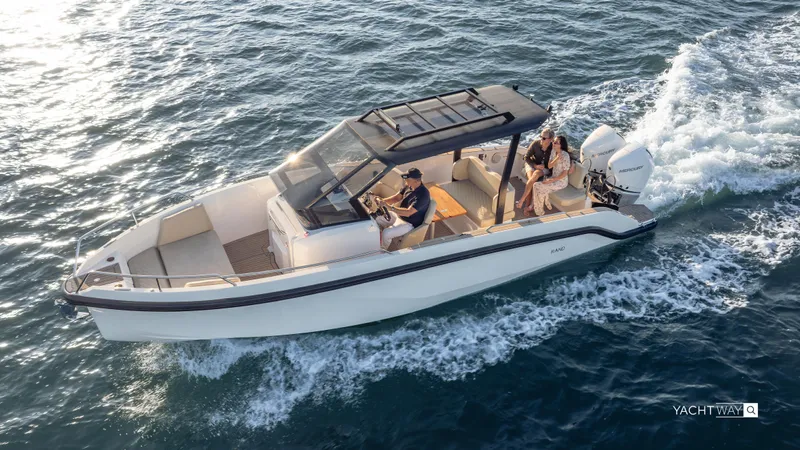  Yacht Photos Pics 2025 Rand Roamer boat cruising on open water, featuring sleek design and modern amenities.