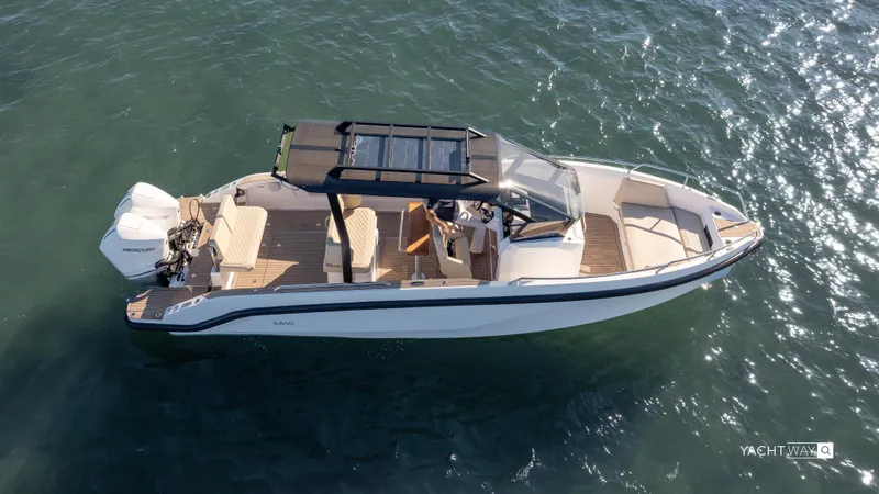  Yacht Photos Pics 2025 Rand Roamer boat cruising on clear water, featuring sleek design and modern amenities.