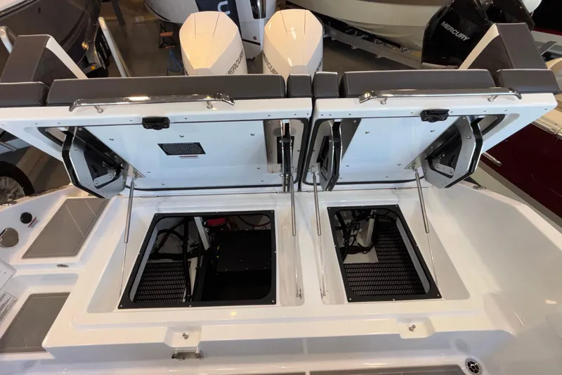  Yacht Photos Pics 2026 Monterey Elite 30 OB boat with open engine compartments, showcasing dual outboard motors.