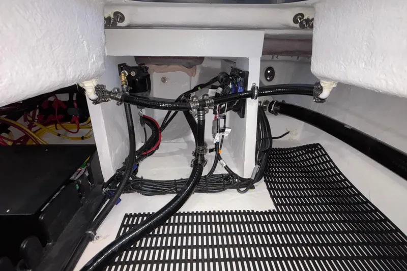  Yacht Photos Pics Engine compartment of 2026 Monterey Elite 30 OB boat, showcasing wiring and hoses.