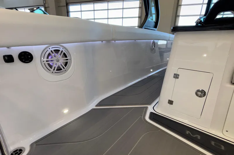  Yacht Photos Pics 2026 Monterey Elite 30 OB boat interior with sleek white seating and modern speaker system.