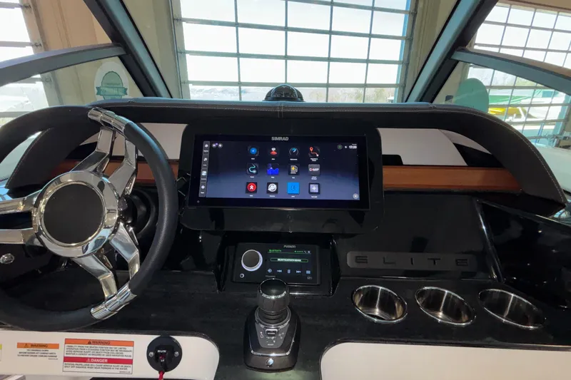  Yacht Photos Pics 2026 Monterey Elite 30 OB dashboard with touchscreen and steering wheel in a modern boat interior.