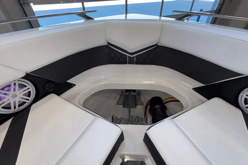  Yacht Photos Pics Interior of 2026 Monterey Elite 30 OB boat with white seating and speakers.