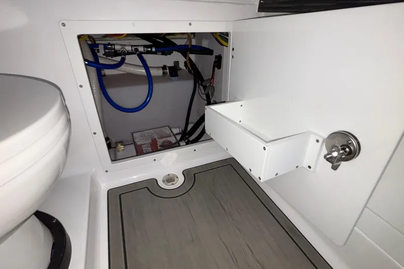 Yacht Photos Pics Interior view of 2026 Monterey Elite 30 OB boat's storage compartment and plumbing.