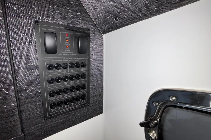 Yacht Photos Pics Control panel inside 2026 Monterey Elite 30 OB boat, featuring switches and battery indicators.