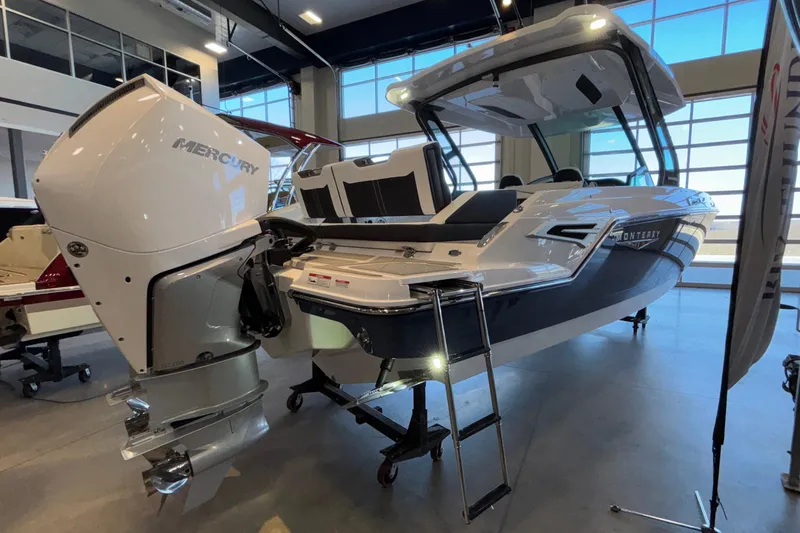 Yacht Photos Pics 2026 Monterey Elite 30 OB boat with Mercury outboard engine in showroom.