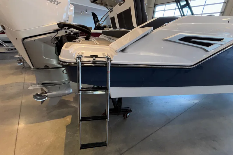  Yacht Photos Pics 2026 Monterey Elite 30 OB boat with ladder and outboard motor in showroom.