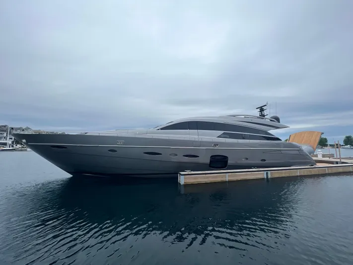 Right Now! Yacht Photos Pics 2017 Pershing 92 Motor Yacht docked on calm water under cloudy skies.