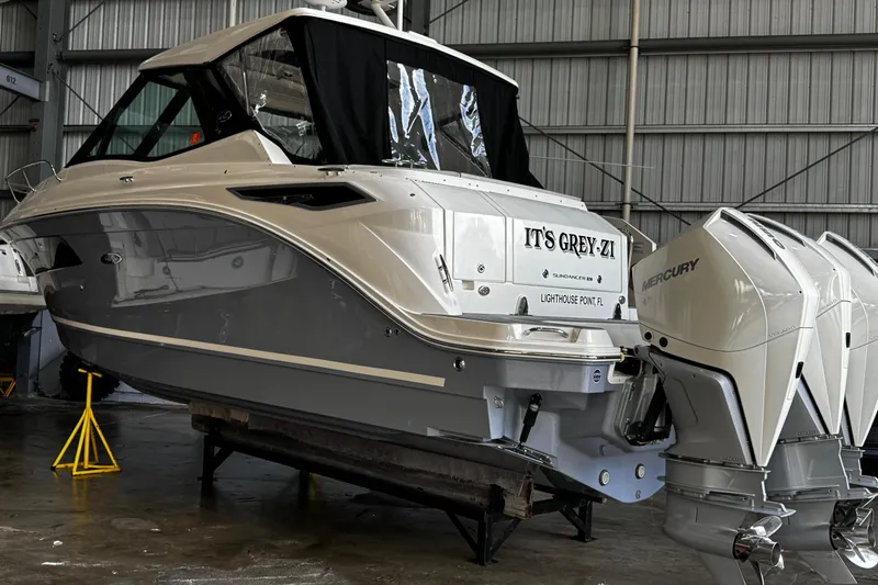  Yacht Photos Pics 2022 Sea Ray Sundancer 320 Outboard in a boat storage facility.