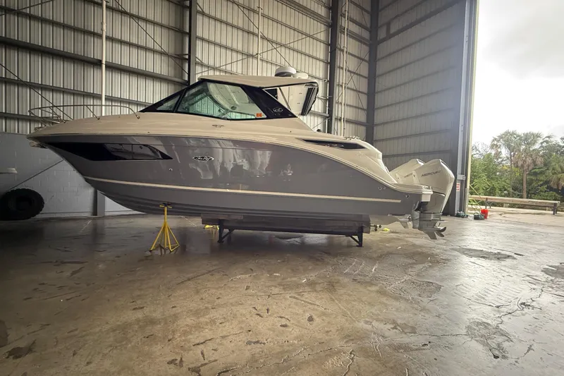  Yacht Photos Pics 2022 Sea Ray Sundancer 320 Outboard in a spacious indoor storage facility.