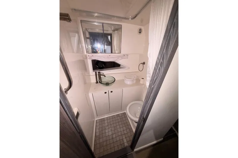  Yacht Photos Pics 2022 Sea Ray Sundancer 320 Outboard bathroom with modern fixtures and compact design.