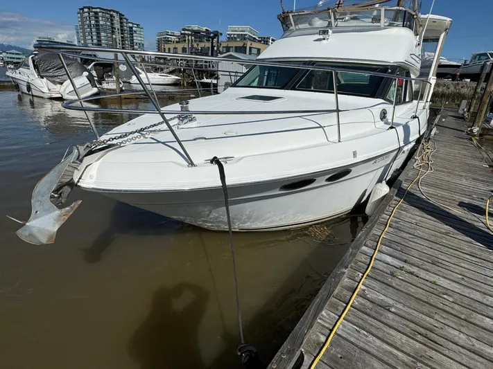  Yacht Photos Pics 2000 Sea Ray 380 Aft Cabin yacht docked at marina with urban skyline background.
