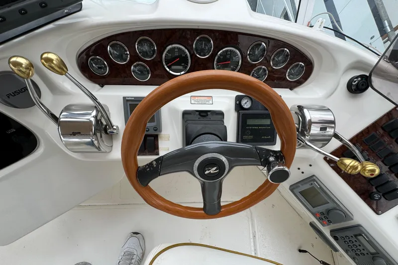  Yacht Photos Pics Steering wheel and controls of a 2000 Sea Ray 380 Aft Cabin boat.