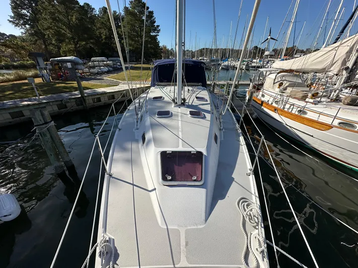 Chesapeake Free Yacht Photos Pics 2006 Catalina 387 sailboat docked at marina, surrounded by other boats and trees.