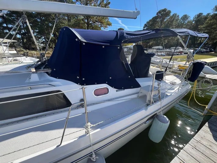 Chesapeake Free Yacht Photos Pics 2006 Catalina 387 sailboat docked, featuring blue canvas covers and a sleek white hull.