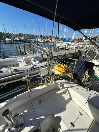 Chesapeake Free Yacht Photos Pics Cockpit view of 2006 Catalina 387 sailboat docked at a marina with other boats.