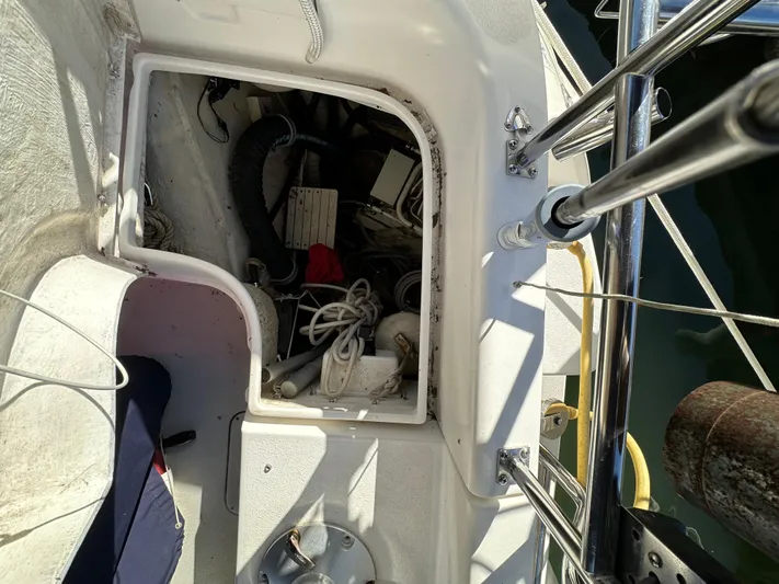 Chesapeake Free Yacht Photos Pics Open storage compartment on a 2006 Catalina 387 sailboat deck, showing various equipment and cables.