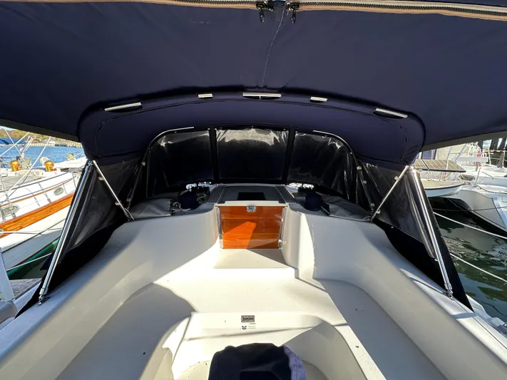 Chesapeake Free Yacht Photos Pics 2006 Catalina 387 sailboat cockpit with navy canopy and wooden hatch, docked at marina.