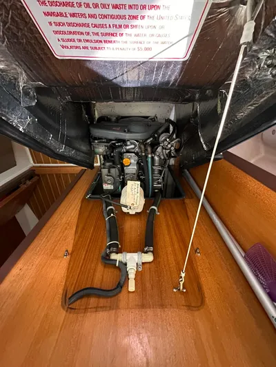 Chesapeake Free Yacht Photos Pics Engine compartment of a 2006 Catalina 387 sailboat, showcasing mechanical components and wooden paneling.
