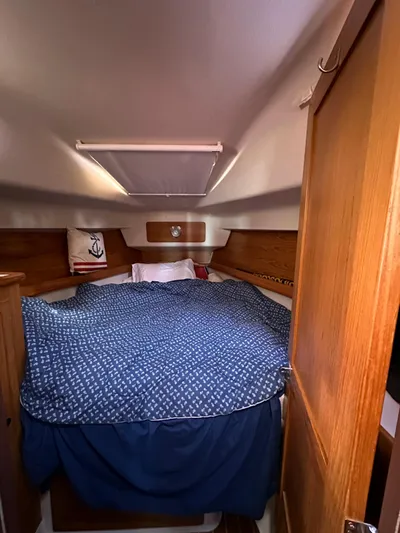 Chesapeake Free Yacht Photos Pics Cozy cabin interior of 2006 Catalina 387 sailboat with blue bedding and wooden accents.