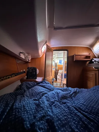 Chesapeake Free Yacht Photos Pics Interior cabin of a 2006 Catalina 387 sailboat with cozy bedding and wooden furnishings.