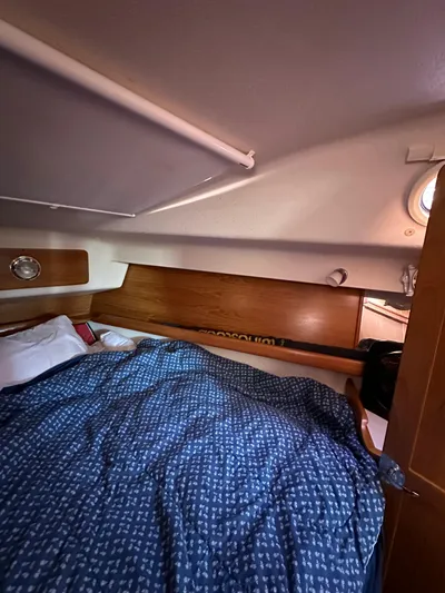 Chesapeake Free Yacht Photos Pics Cozy cabin interior of 2006 Catalina 387 sailboat with blue bedding and wooden accents.