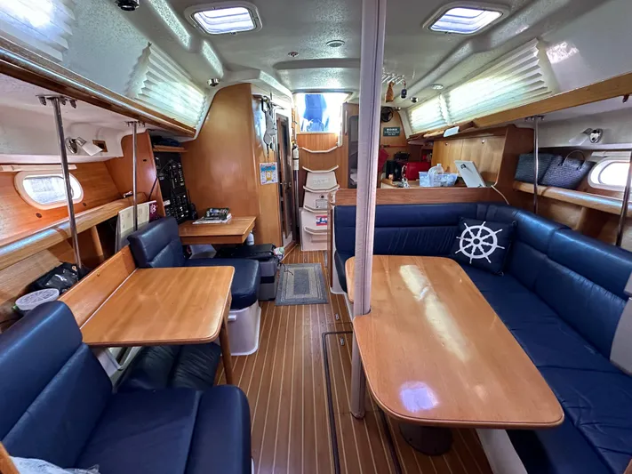 Chesapeake Free Yacht Photos Pics Interior of 2006 Catalina 387 sailboat with wooden tables and blue seating.