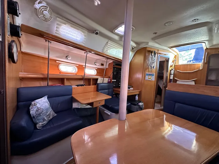 Chesapeake Free Yacht Photos Pics Interior of 2006 Catalina 387 sailboat with wooden furnishings and blue seating.