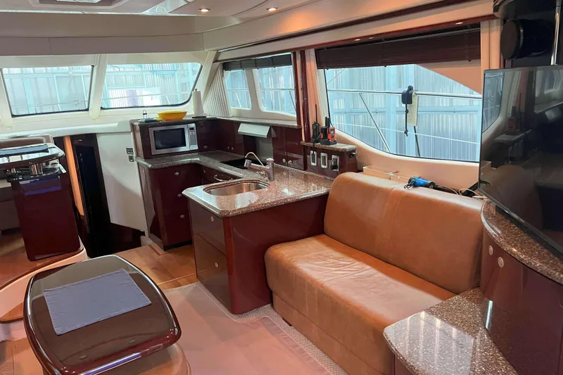 Elisabeth Jane Yacht Photos Pics Luxurious interior of 2008 Sea Ray 52 Sedan Bridge yacht with modern kitchen and seating area.