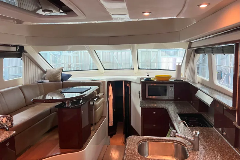 Elisabeth Jane Yacht Photos Pics Luxurious interior of 2008 Sea Ray 52 Sedan Bridge yacht with modern kitchen and seating area.