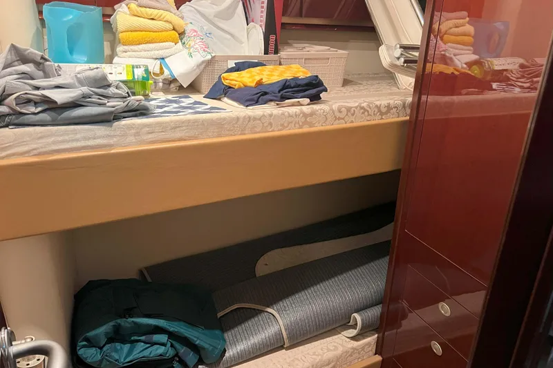 Elisabeth Jane Yacht Photos Pics Interior storage area of a 2008 Sea Ray 52 Sedan Bridge yacht with folded clothes and towels.