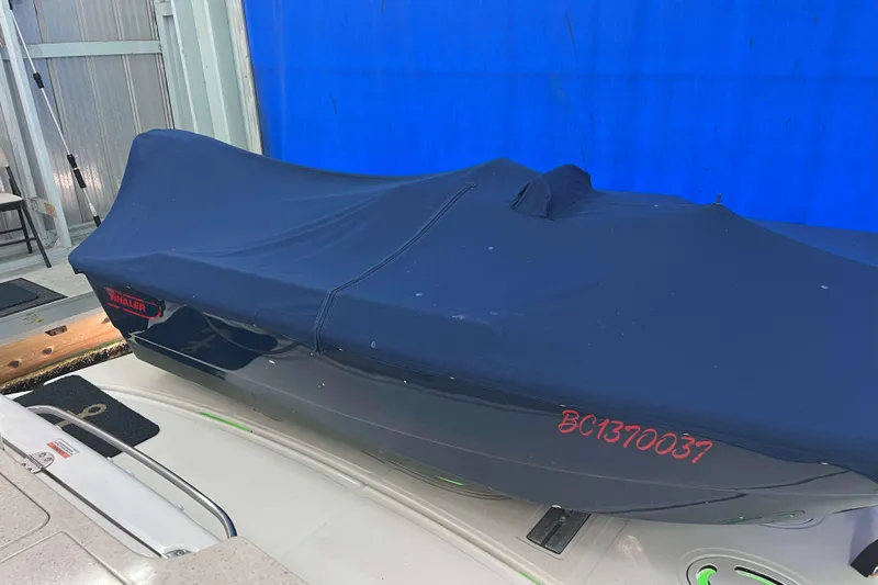 Elisabeth Jane Yacht Photos Pics Covered 2008 Sea Ray 52 Sedan Bridge boat in storage, blue tarp, indoor setting.