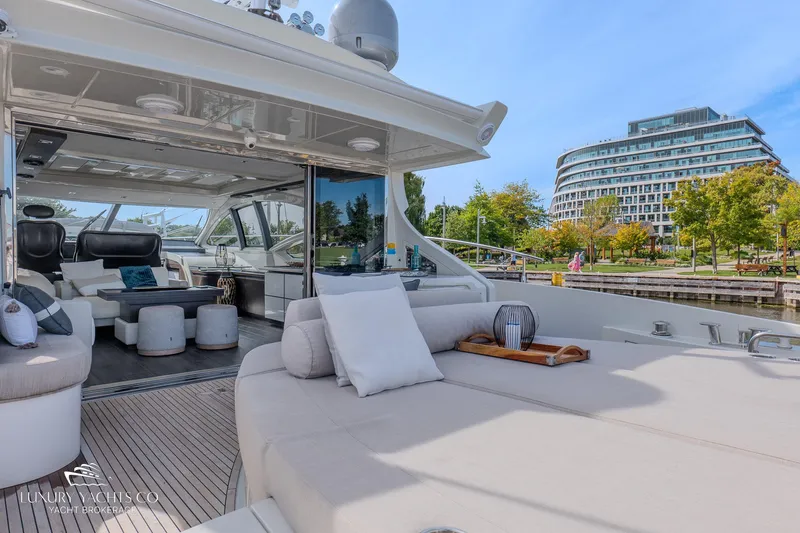  Yacht Photos Pics Luxurious 2010 Azimut 62S yacht with elegant interior and spacious deck, docked near modern architecture.