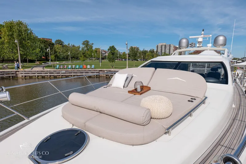  Yacht Photos Pics Luxurious 2010 Azimut 62S yacht with sunbathing deck, docked by a scenic waterfront.