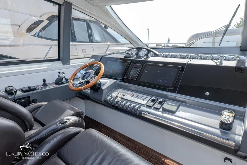 Yacht Photos Pics Luxurious 2010 Azimut 62S yacht helm with modern controls and leather seating.