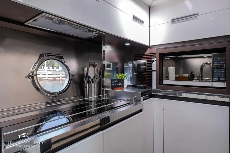  Yacht Photos Pics Modern kitchen interior on 2010 Azimut 62S yacht with sleek appliances and porthole view.