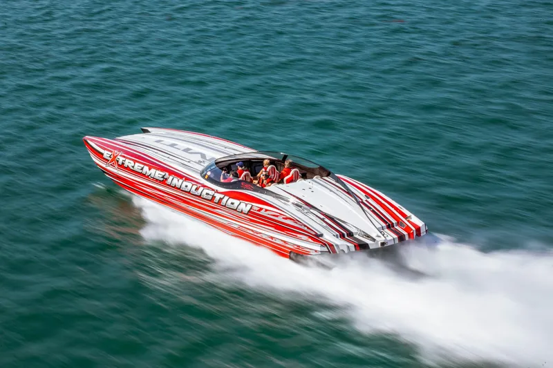  Yacht Photos Pics High-speed MTI 48 powerboat racing on water, featuring bold red and white design.