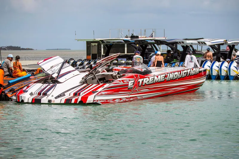  Yacht Photos Pics High-performance MTI 48 speedboat docked, featuring bold red and white graphics, 2019 model.