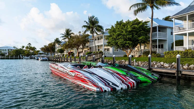  Yacht Photos Pics 2019 MTI 48 speedboats docked by waterfront homes with palm trees.