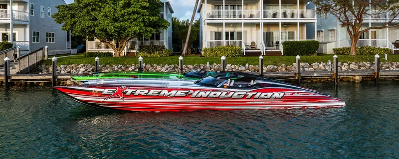  Yacht Photos Pics Red and white MTI 48 speedboat docked near waterfront homes, 2019 model.