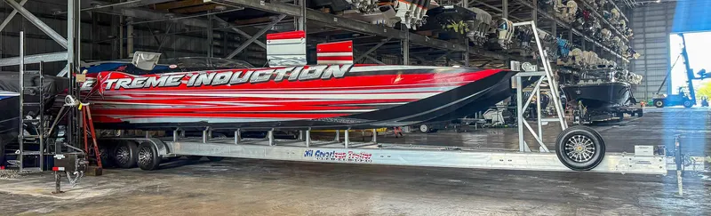  Yacht Photos Pics Red and black MTI 48 speedboat on trailer in storage facility, 2019 model.