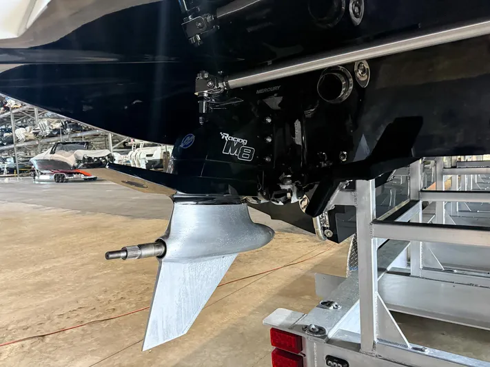  Yacht Photos Pics Close-up of a 2019 MTI 48 boat's propeller and engine in a storage facility.