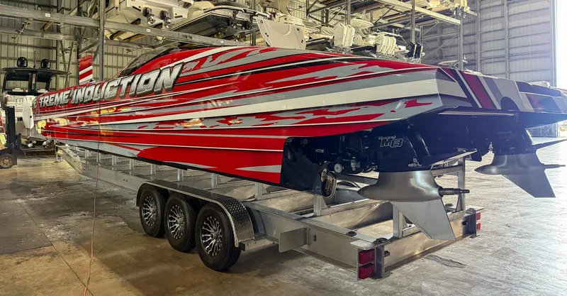  Yacht Photos Pics Red MTI 48 speedboat on trailer in warehouse, 2019 model.