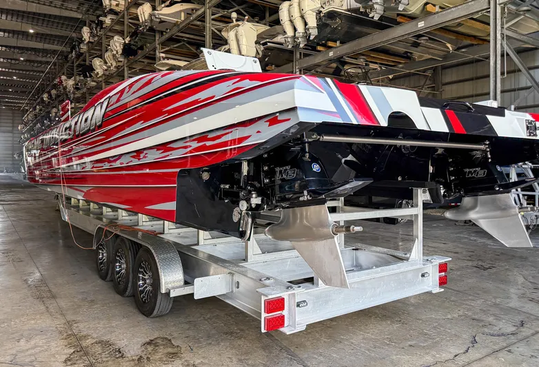  Yacht Photos Pics Red and white MTI 48 boat on trailer in warehouse, 2019 model.